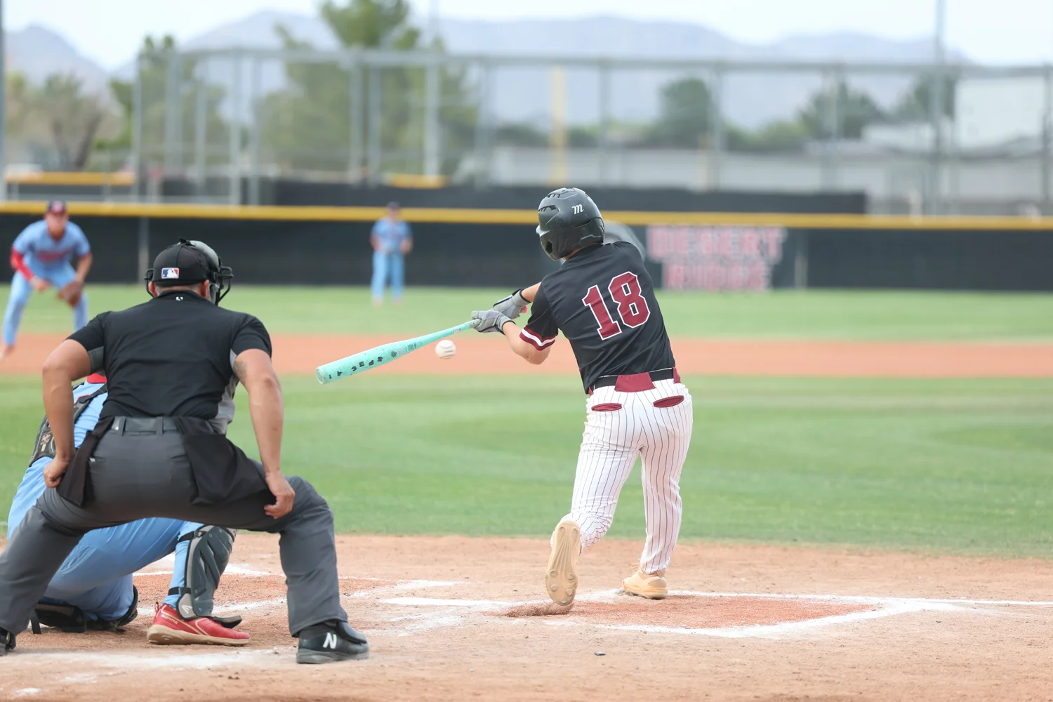 Batter taking a swing at the ball